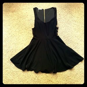 Bebe dress with side cutouts and gold buckles